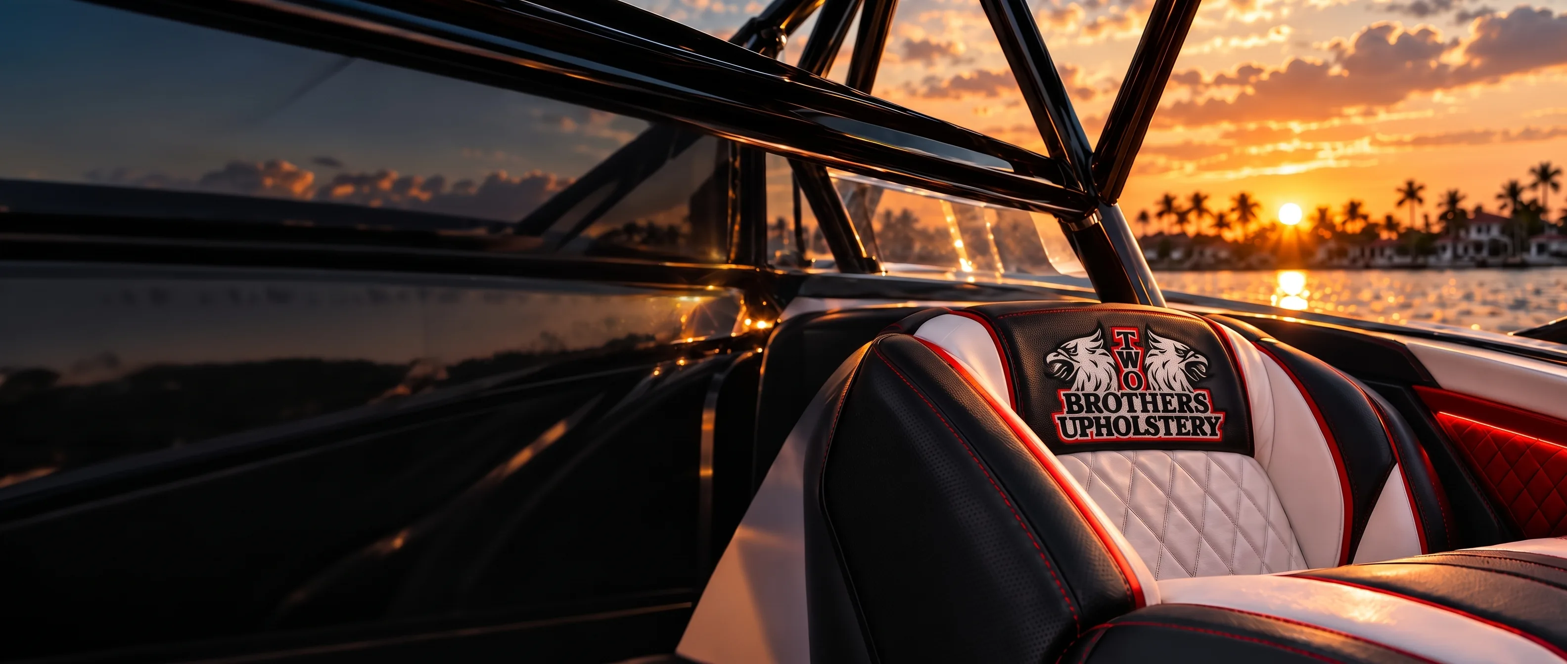Two Brothers Upholstery custom black, white and red diamond-stitched boat seat at sunset